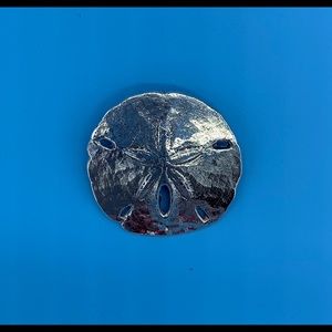 Mignon Faget silver sand dollar pendant.